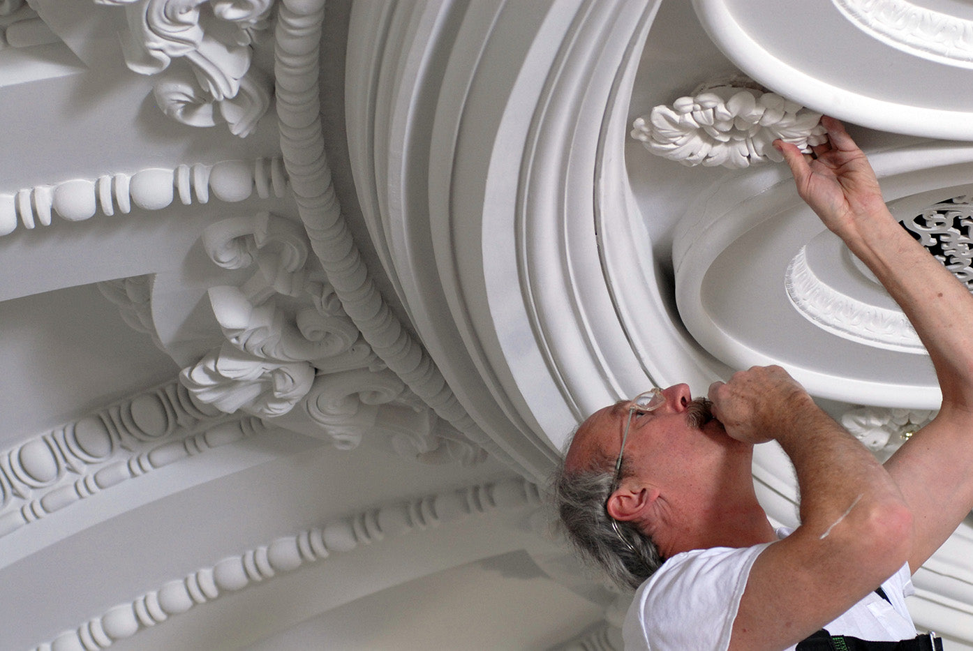 Person working on decorative ceiling molding