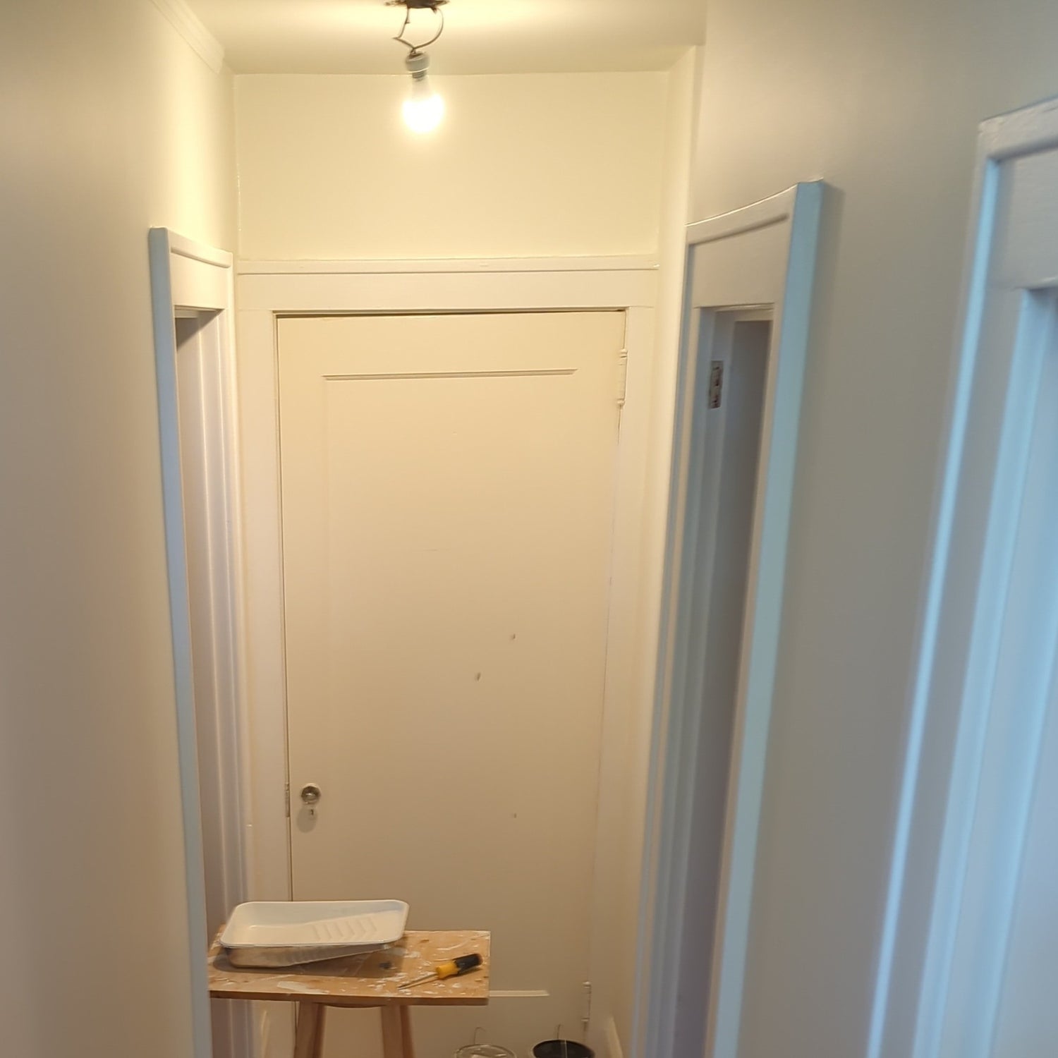 Restored plaster walls around a door frame after reattachment and finishing work.