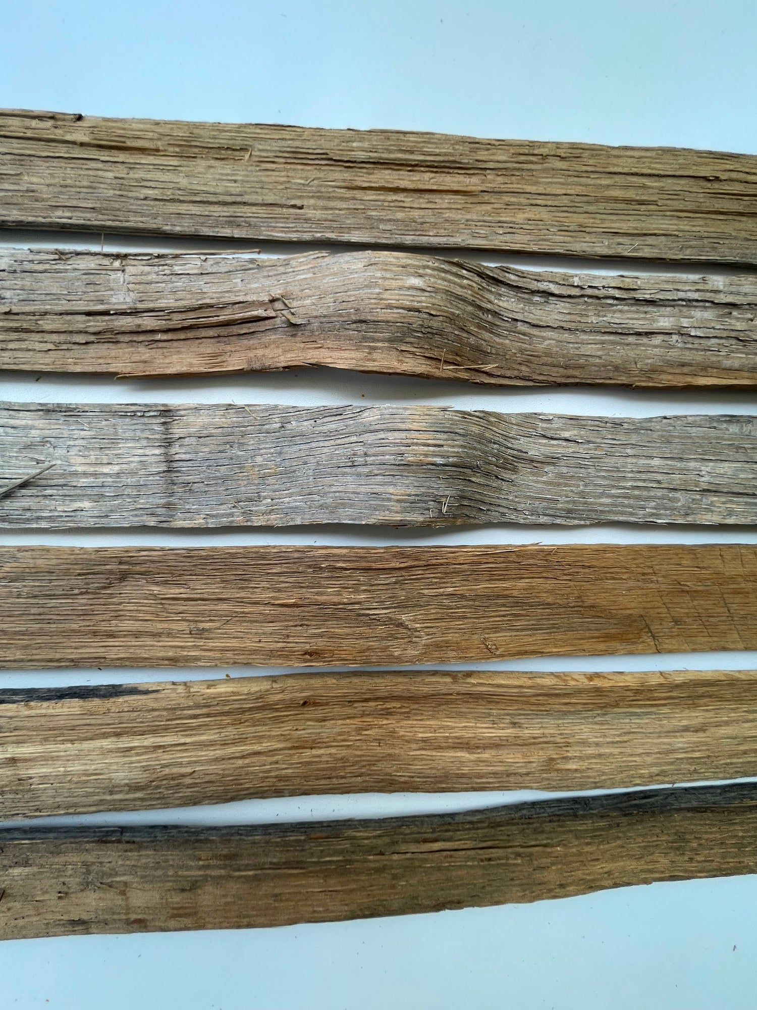 Three wooden planks of different colors on a white background