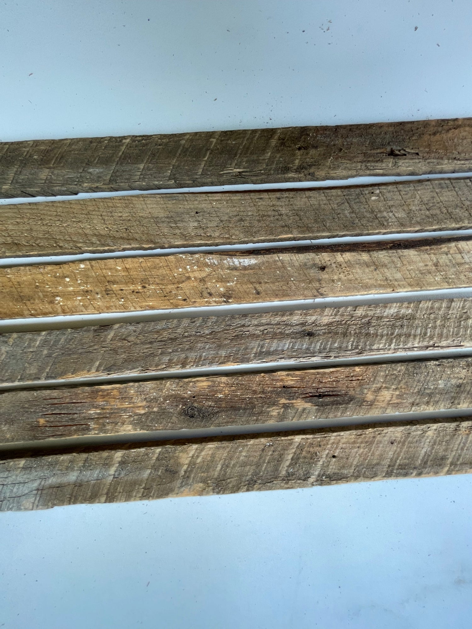 Five wooden planks of varying sizes on a white background