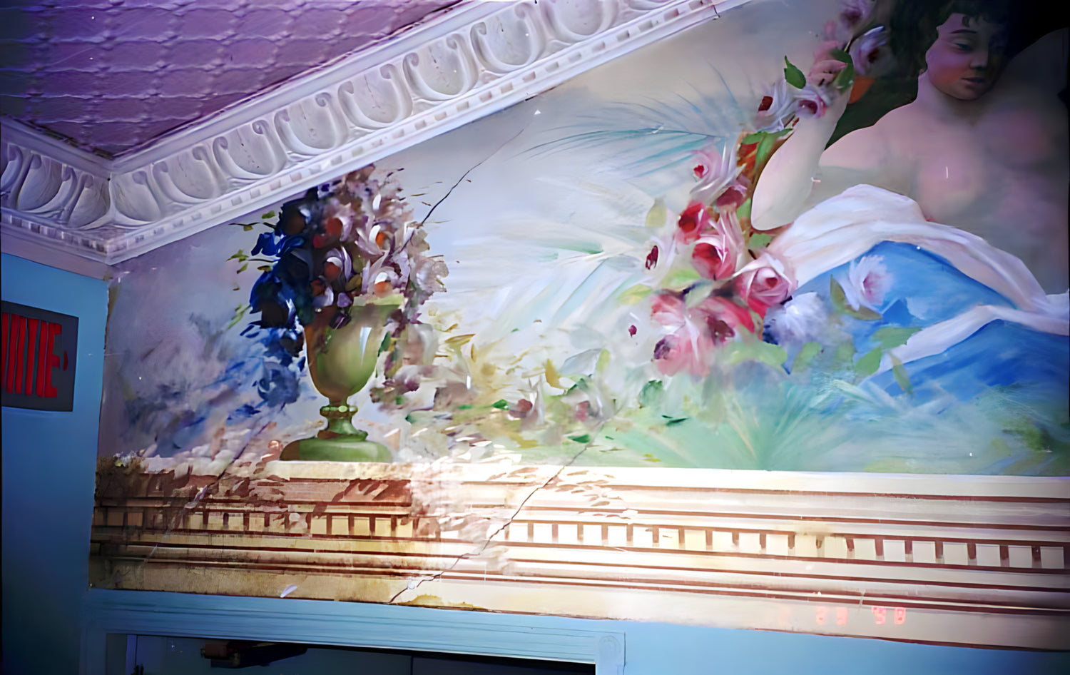 Decorative mural with classical design featuring a figure, flowers, and architectural elements.