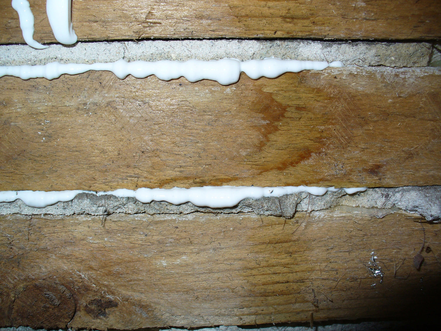 Wooden lath strips with adhesive applied during plaster reattachment from the back