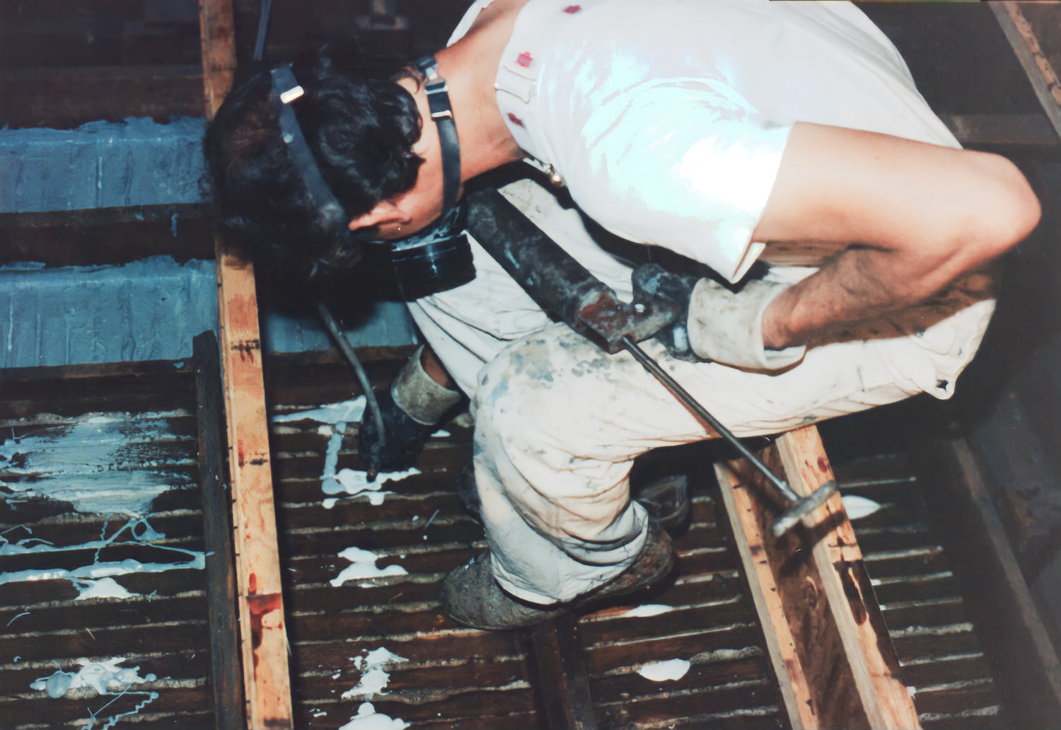 Person using a power tool on a wooden surface